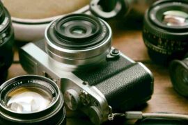 camera-lens-binocular-canvas-shoes-sports-bottle-retro-wooden-table_11zon